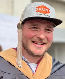 Dave Chernow, Cofounder of BRUNT, smiling in a BRUNT cap.